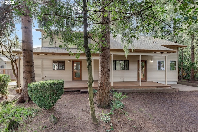 view of front of property featuring roof with shingles and covered porch