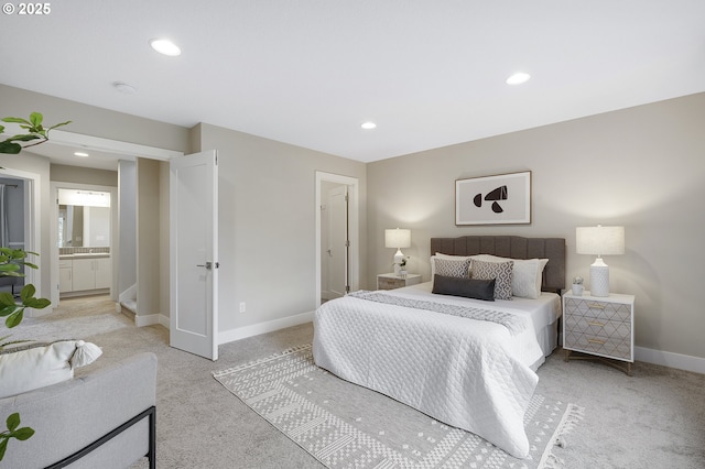 bedroom featuring ensuite bathroom, recessed lighting, light colored carpet, and baseboards