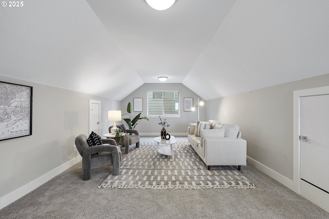 living room with vaulted ceiling, carpet flooring, and baseboards