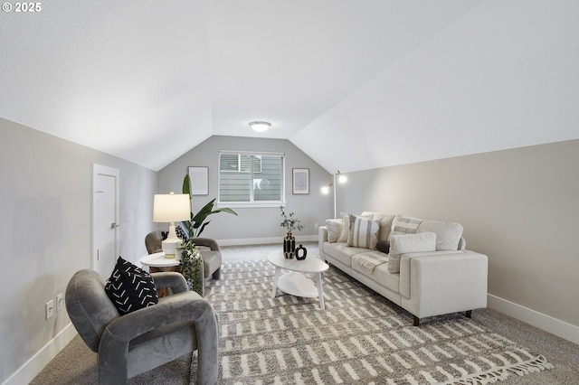 living room with lofted ceiling, baseboards, and carpet floors