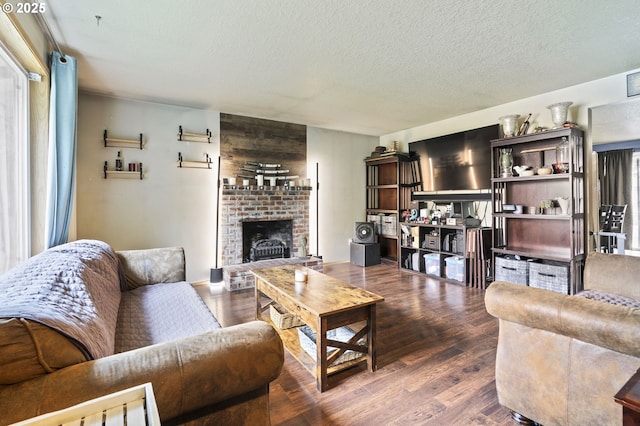 14717 NE 51st St, Vancouver, WA 98682 - living room with wood finished floors, a brick fireplace, and a textured ceiling