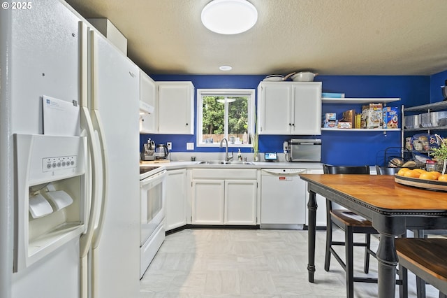 14717 NE 51st St, Vancouver, WA 98682 - kitchen featuring white appliances, a sink, white cabinetry, light countertops, and a textured ceiling