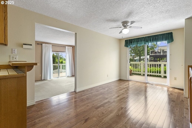 540 NE 23rd Pl, Gresham, OR 97030 - unfurnished living room featuring wood finished floors, ceiling fan, and a textured ceiling
