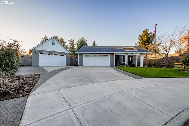 ranch-style home featuring a garage and a yard