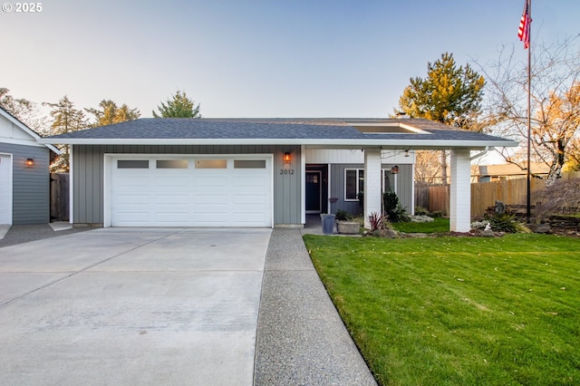 view of front of property featuring a garage and a front yard