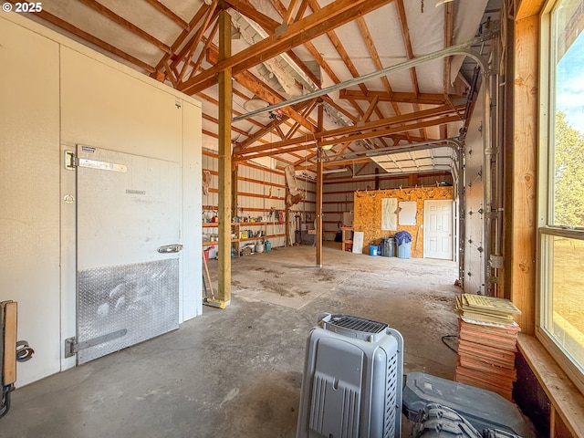 25405 SE Bear Creek Rd, Prineville, OR 97754 - misc room featuring unfinished concrete floors, a garage, and lofted ceiling