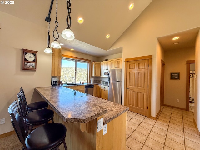 25405 SE Bear Creek Rd, Prineville, OR 97754 - kitchen featuring a peninsula, a breakfast bar, baseboards, recessed lighting, and stainless steel appliances