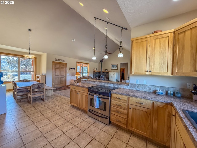 25405 SE Bear Creek Rd, Prineville, OR 97754 - kitchen with electric range, hanging light fixtures, vaulted ceiling, light tile patterned floors, and a peninsula