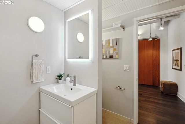 1314 NW Irving St Unit 404, Portland, OR 97209 - bathroom with wood finished floors, vanity, and baseboards