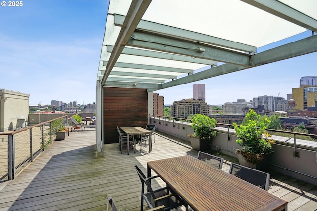 1314 NW Irving St Unit 404, Portland, OR 97209 - wooden deck with outdoor dining space, a pergola, and a skyline view