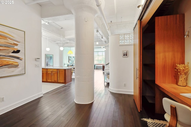 1314 NW Irving St Unit 404, Portland, OR 97209 - hallway featuring dark wood finished floors, baseboards, and beamed ceiling