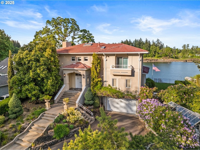12760 S Fielding Rd, Lake Oswego, OR 97034 - view of front of house featuring a balcony, stucco siding, an attached garage, driveway, and stairway