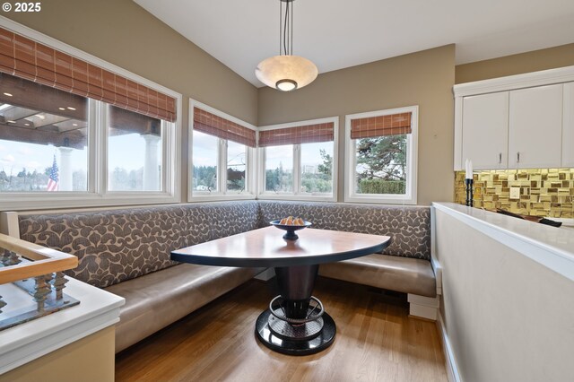 12760 S Fielding Rd, Lake Oswego, OR 97034 - kitchen with a sink, white cabinetry, dishwasher, and a kitchen bar
