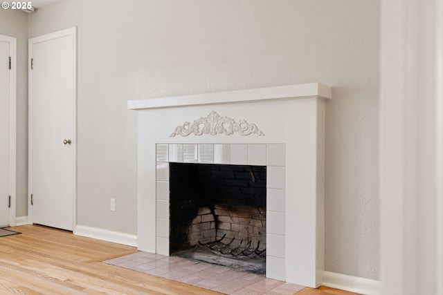 4060 SW 96th Ave, Beaverton, OR 97005 - detailed view of wood finished floors, a tiled fireplace, and baseboards