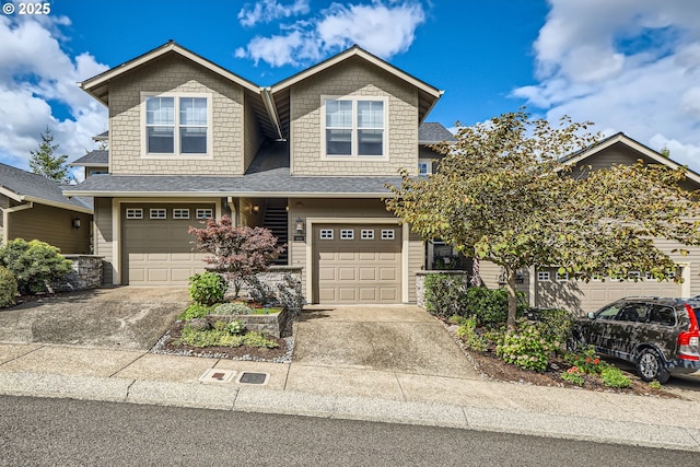 view of front facade with an attached garage, roof with shingles, and driveway