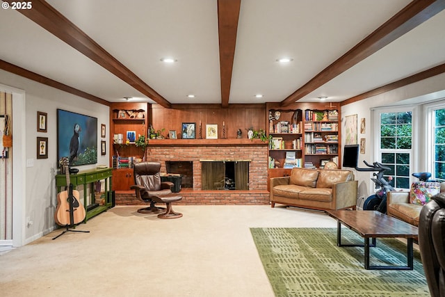 carpeted living area with beam ceiling, wooden walls, recessed lighting, and a fireplace