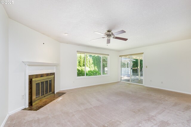 20753 SW Martinazzi Ave, Tualatin, OR 97062 - unfurnished living room featuring carpet floors, a ceiling fan, a tile fireplace, a textured ceiling, and baseboards