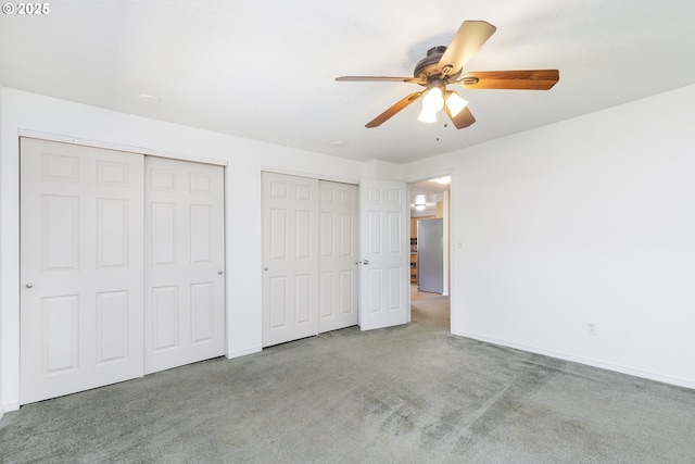 20753 SW Martinazzi Ave, Tualatin, OR 97062 - unfurnished bedroom featuring multiple closets, carpet floors, baseboards, and a ceiling fan
