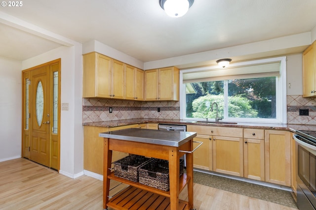 20753 SW Martinazzi Ave, Tualatin, OR 97062 - kitchen featuring a sink, light wood-type flooring, stainless steel countertops, light brown cabinets, and tasteful backsplash