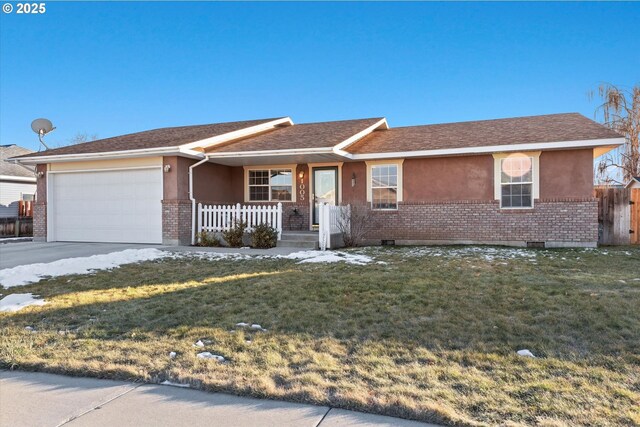 single story home featuring a garage and a front yard