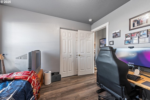 office space with dark wood finished floors and a textured ceiling