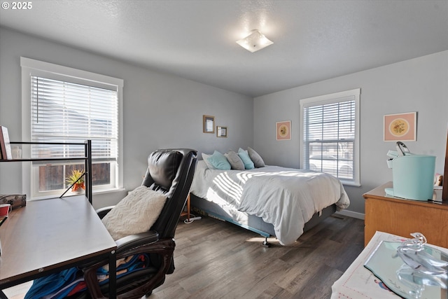 bedroom featuring dark wood-style flooring and baseboards