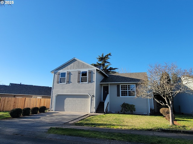 split level home with a garage and a front lawn