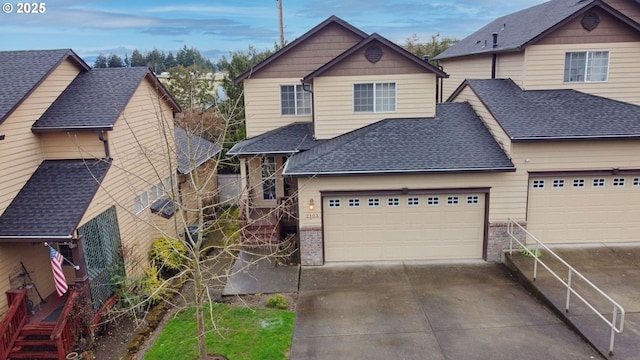 view of front of property featuring brick siding, an attached garage, driveway, and a shingled roof