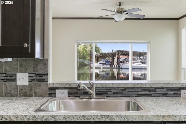 14426 NW Larson Rd Unit 2, Portland, OR 97231 - kitchen featuring a sink, crown molding, tasteful backsplash, light countertops, and healthy amount of natural light