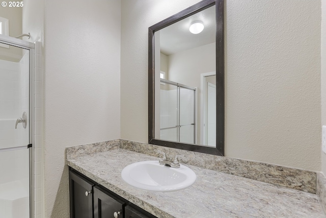 14426 NW Larson Rd Unit 2, Portland, OR 97231 - bathroom with a textured wall, a stall shower, and vanity