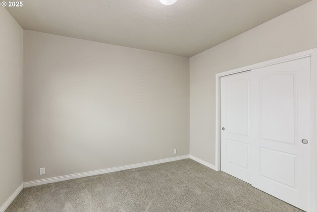 14426 NW Larson Rd Unit 2, Portland, OR 97231 - unfurnished bedroom featuring carpet flooring, baseboards, and a closet