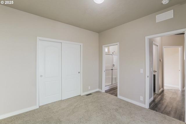 14426 NW Larson Rd Unit 2, Portland, OR 97231 - unfurnished bedroom with baseboards, dark colored carpet, a closet, and ensuite bath