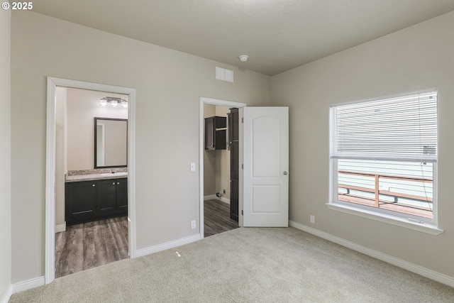 14426 NW Larson Rd Unit 2, Portland, OR 97231 - unfurnished bedroom featuring carpet, a walk in closet, and baseboards