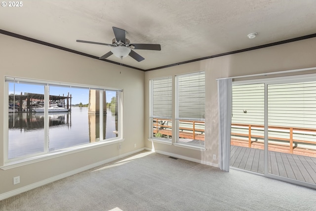 14426 NW Larson Rd Unit 2, Portland, OR 97231 - carpeted empty room with ceiling fan, baseboards, a smoke detector, a water view, and crown molding