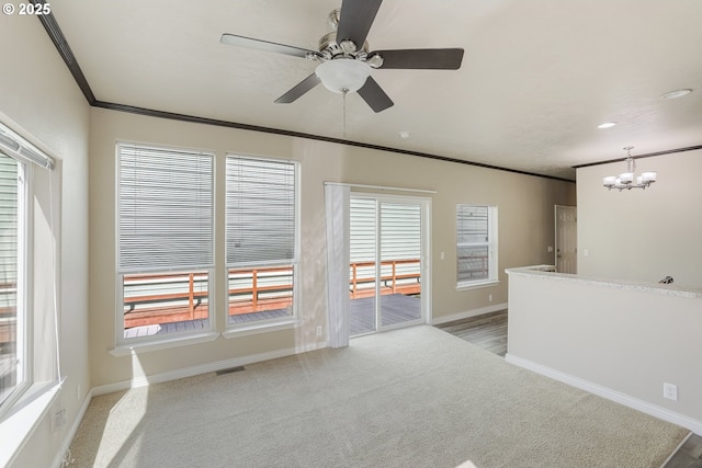14426 NW Larson Rd Unit 2, Portland, OR 97231 - spare room with a chandelier, crown molding, ceiling fan, healthy amount of natural light, and light colored carpet