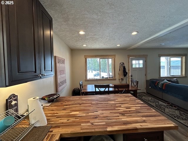 dining area featuring recessed lighting, a textured ceiling, and wood finished floors