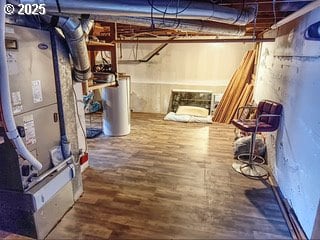 175 W Baltimore St, Heppner, OR 97836 - unfinished below grade area featuring water heater, wood finished floors, and heating unit