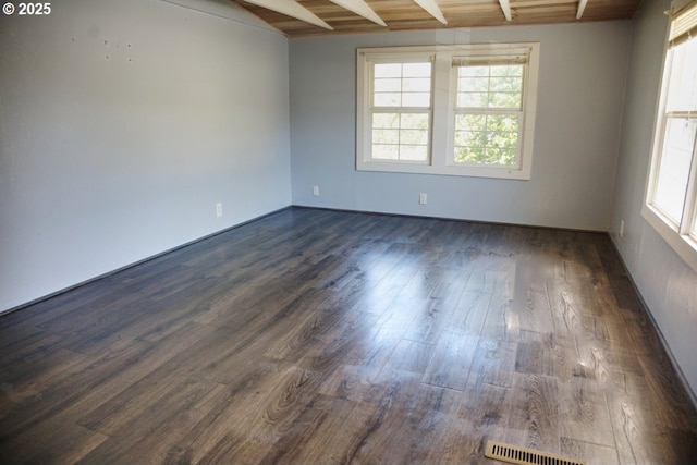 175 W Baltimore St, Heppner, OR 97836 - empty room featuring dark wood finished floors, wooden ceiling, and baseboards