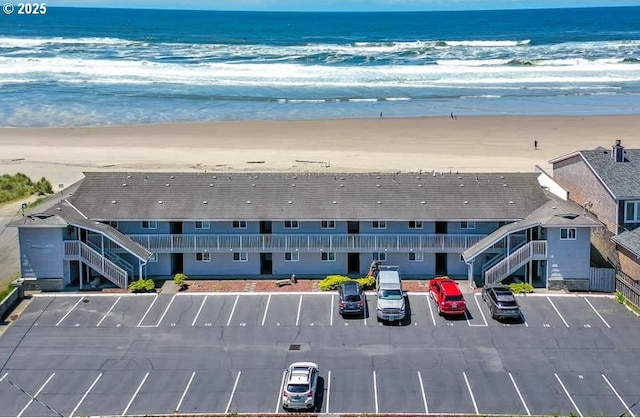 bird's eye view featuring a view of the beach and a water view