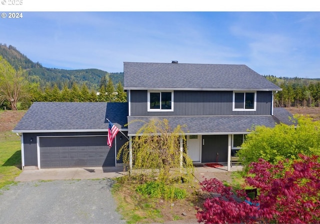 view of front of property with a mountain view and a garage