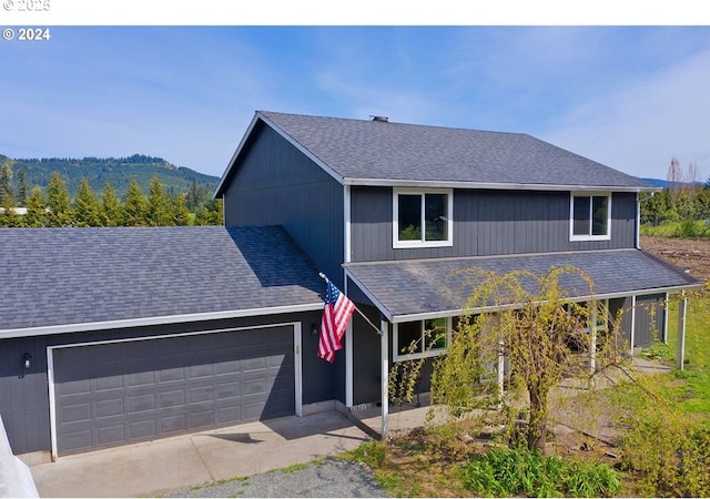 view of property with a mountain view and a garage