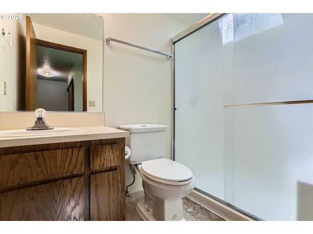 full bath featuring vanity, tile patterned flooring, a stall shower, and toilet