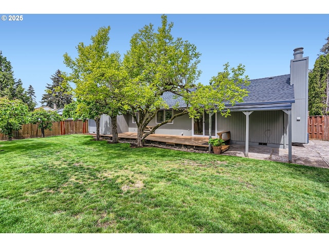 view of yard with a patio, fence, and a wooden deck