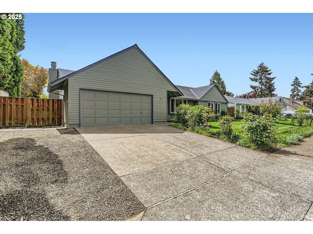 ranch-style house with a garage, fence, and concrete driveway