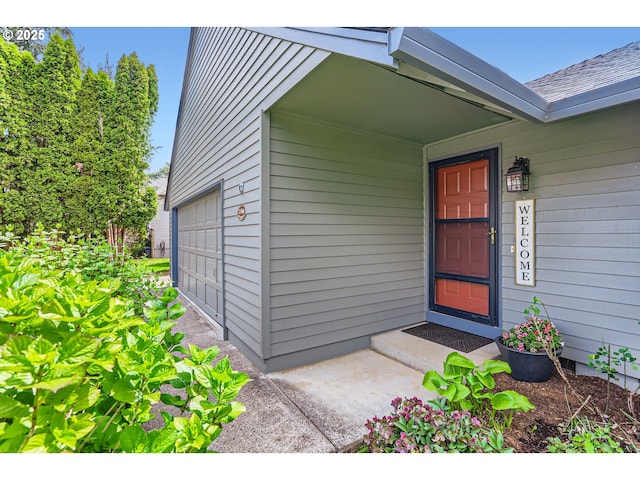 doorway to property with a garage
