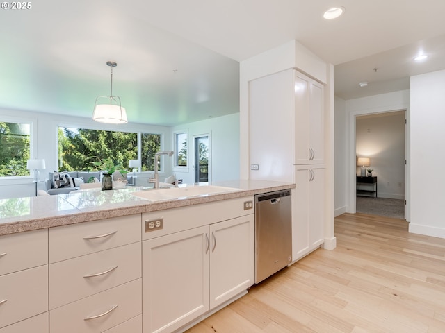 790 NW Westover Sq Unit 8, Portland, OR 97210 - kitchen with dishwasher, tile countertops, a sink, light wood-style floors, and recessed lighting