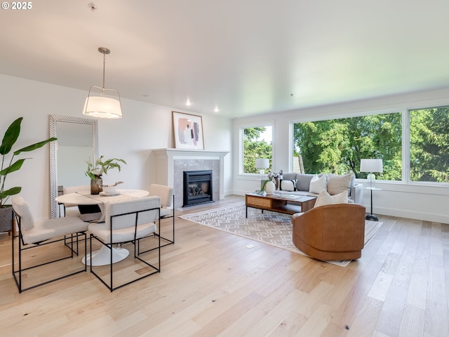 790 NW Westover Sq Unit 8, Portland, OR 97210 - living room with light wood-style flooring, plenty of natural light, a tiled fireplace, and baseboards