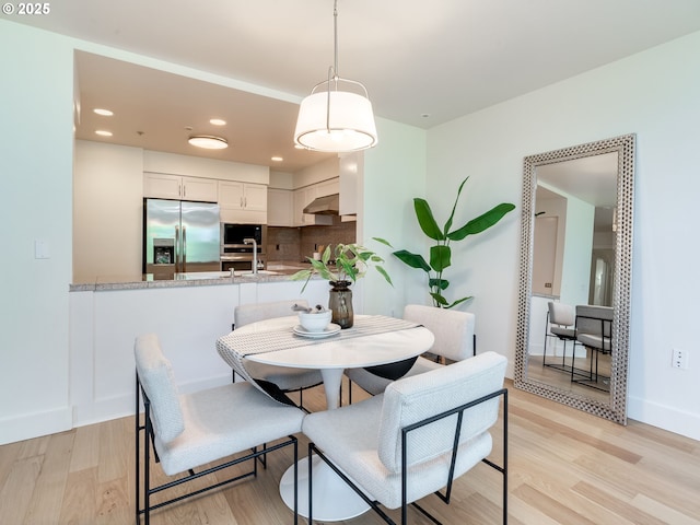 790 NW Westover Sq Unit 8, Portland, OR 97210 - dining space with light wood-type flooring, baseboards, and recessed lighting