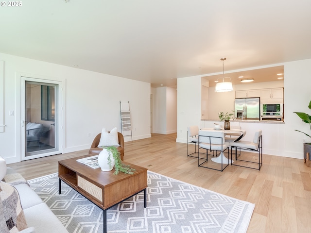 790 NW Westover Sq Unit 8, Portland, OR 97210 - living area with light wood-type flooring and baseboards