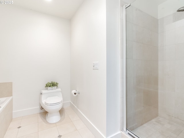 790 NW Westover Sq Unit 8, Portland, OR 97210 - bathroom featuring toilet, a stall shower, tile patterned floors, a bath, and baseboards